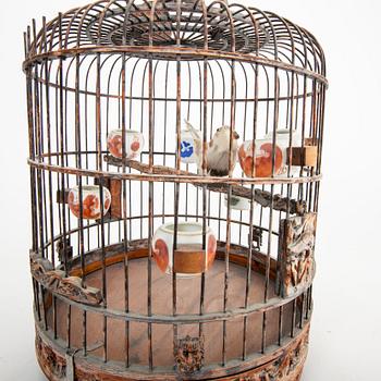 A Chinese bird cage with bird feeders, 20th Century.