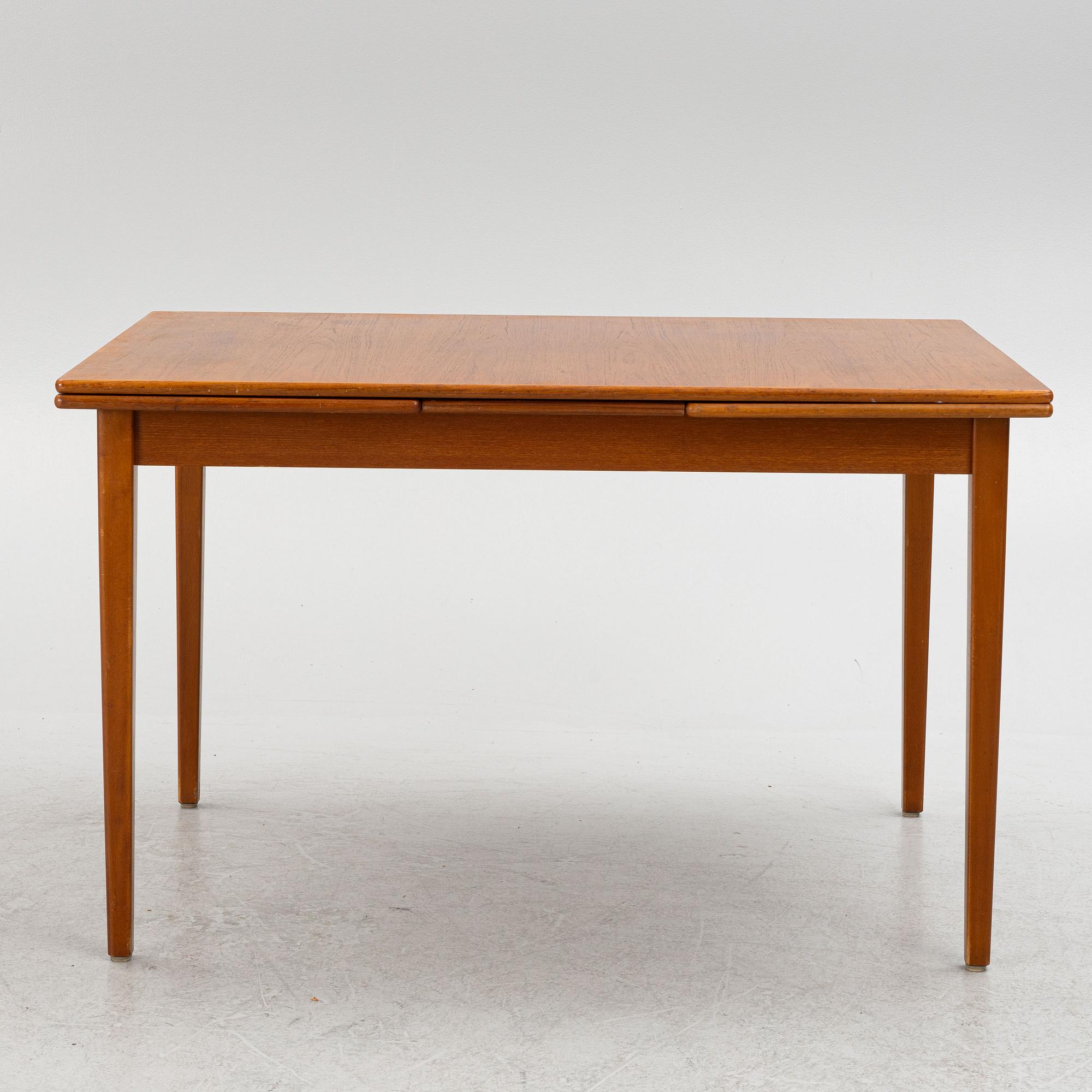 A dining table with four chairs, mid 20th century.