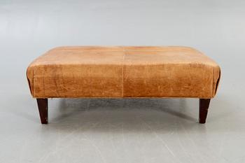 A leather ottoman/coffee table alter part of the 20th century.
