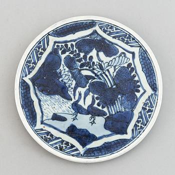 A Chinese silk embroidery, early 20th Century, a chinese blue and white placque, Ming dynasty (1368-1644).