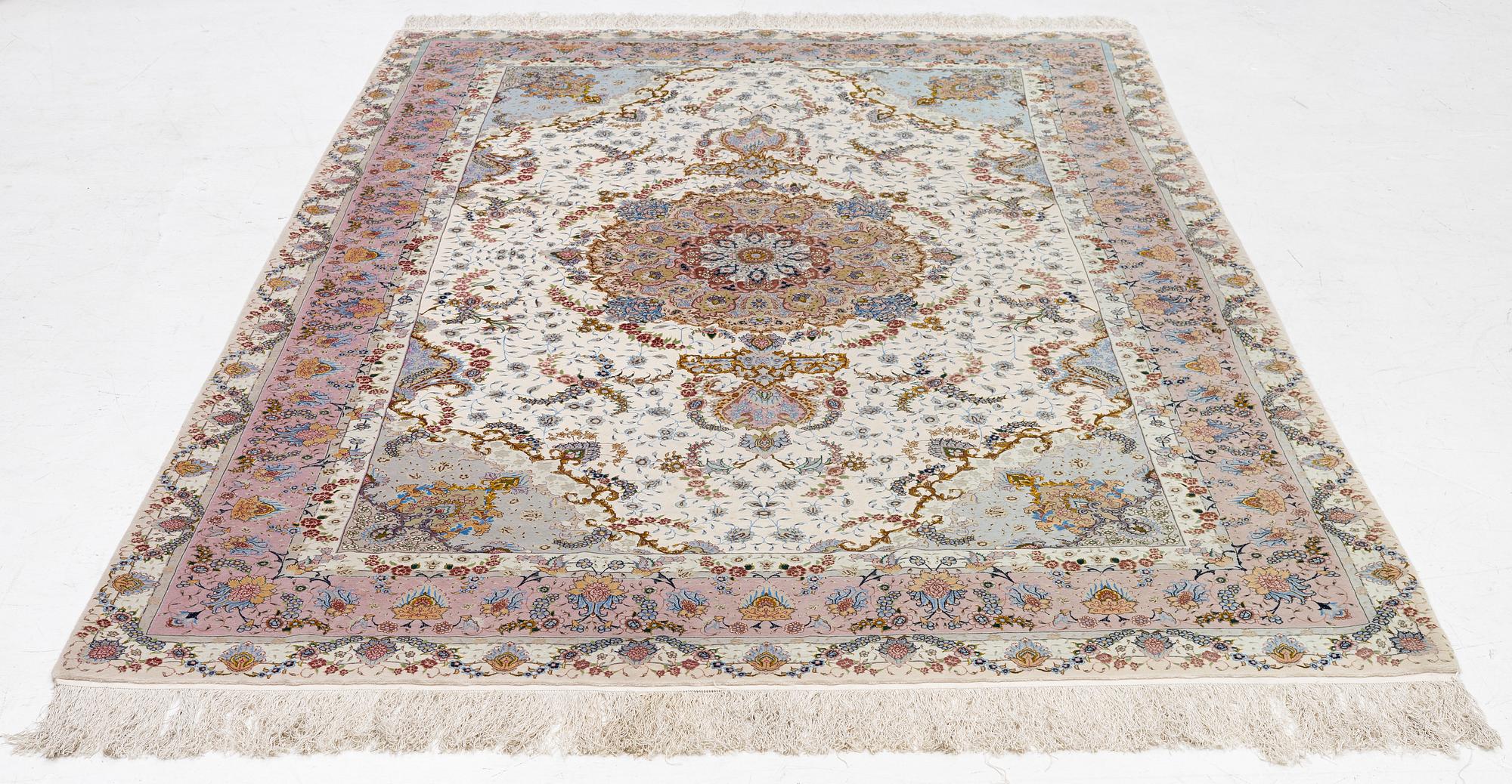 A Tabriz carpet north west Persia, part silk, c. 314 x 197 cm.