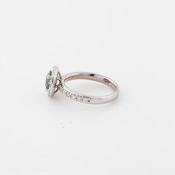 A treated green diamond and briliant cut diamonds.