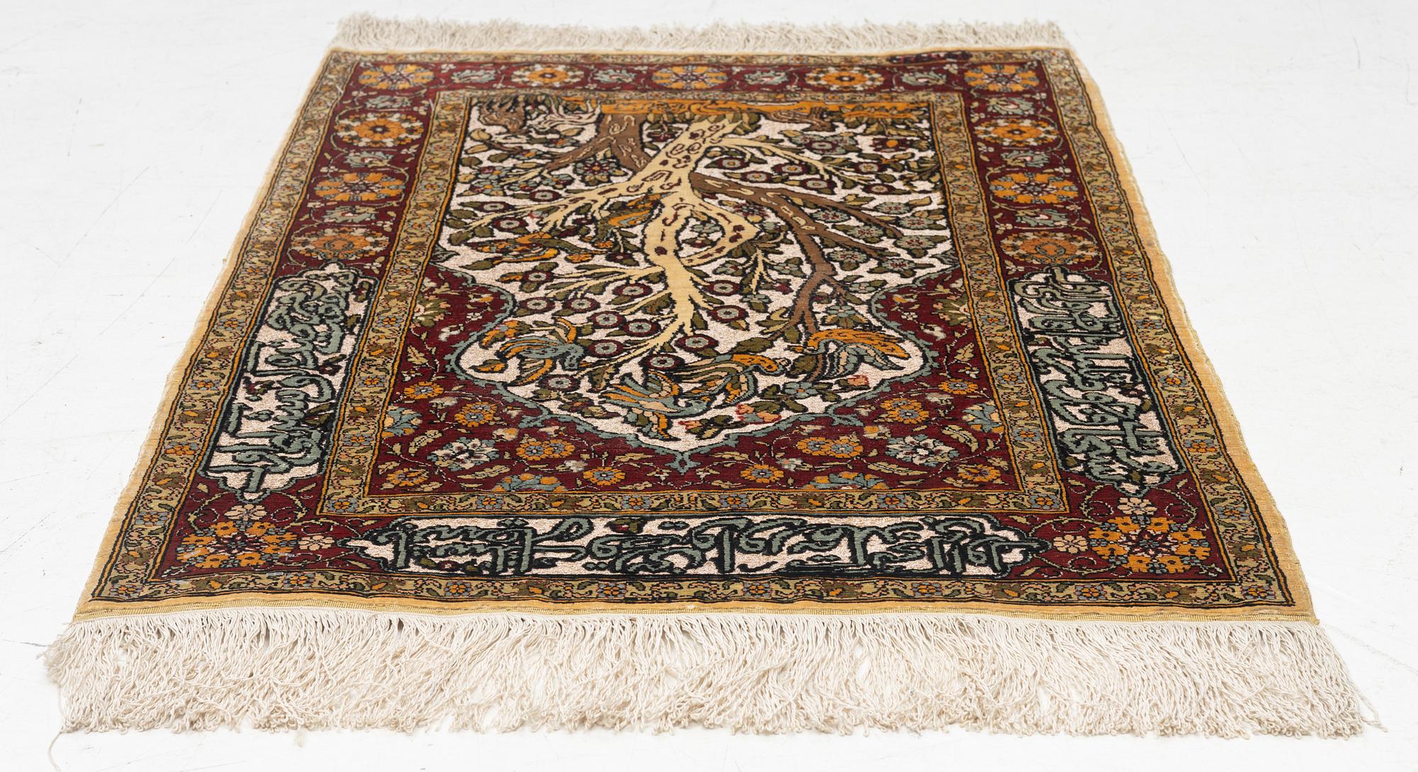 A silke rug, Hereke, signed, c. 90 x 61 cm.