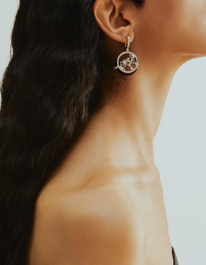 A pair of Cartier Panthère earrings in 18K white gold set with round brilliant-cut diamonds with a total weight of ca 5 cts, emeralds, onyx and black nephrite.