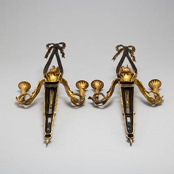 A pair of Louis XVI style brass wall sconces, first half of the 20th Century.