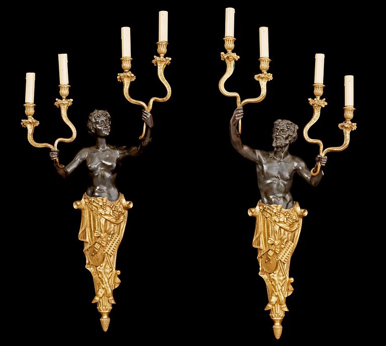 A pair of Louis Philippe 1830/1840's gilt and patinated bronze four-light wall-lights.