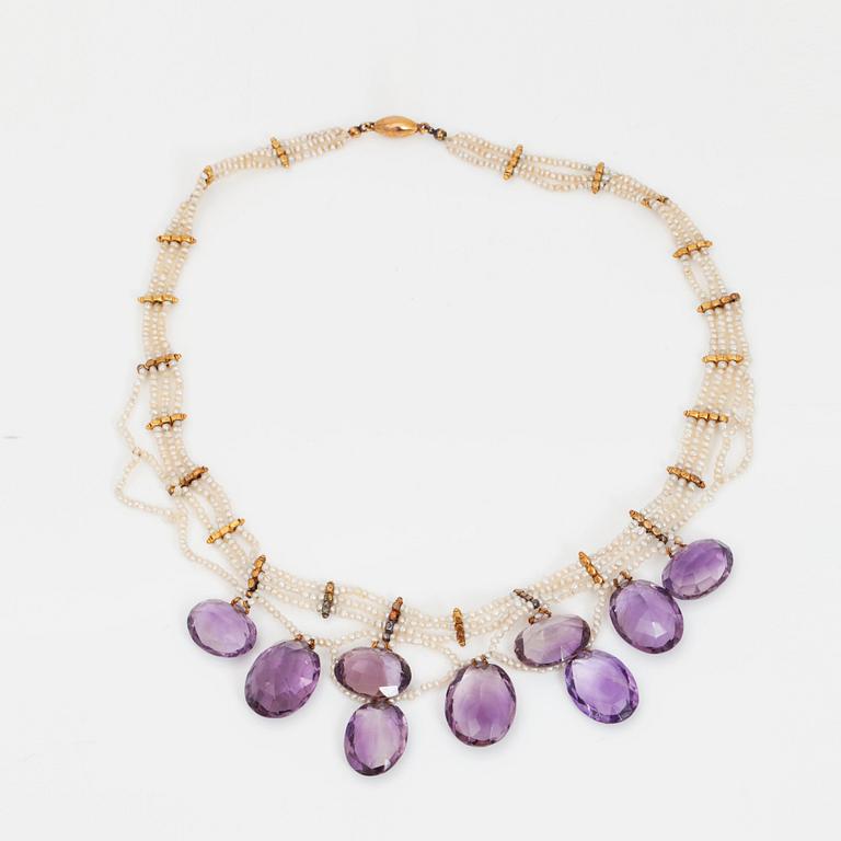 An amethyst and probably natural seed pearl necklace.