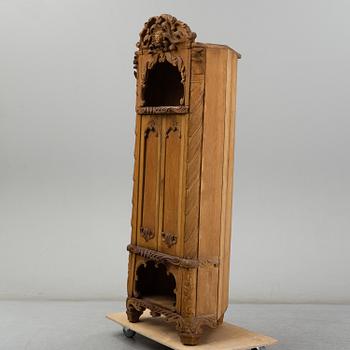 KNUT FJAESTAD, a folk art oak cabinet, signed KF 1935.