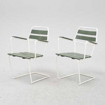 A mid  20th Century garden set with a table and four chairs.