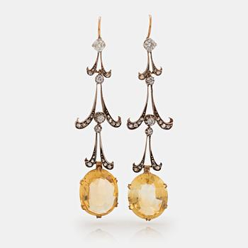 938. A pair of 14K gold and silver earrings set with faceted citrines and round brilliant- and old-cut diamonds.