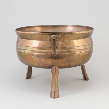 A Swedish 18th/19th century brass pot on three legs.