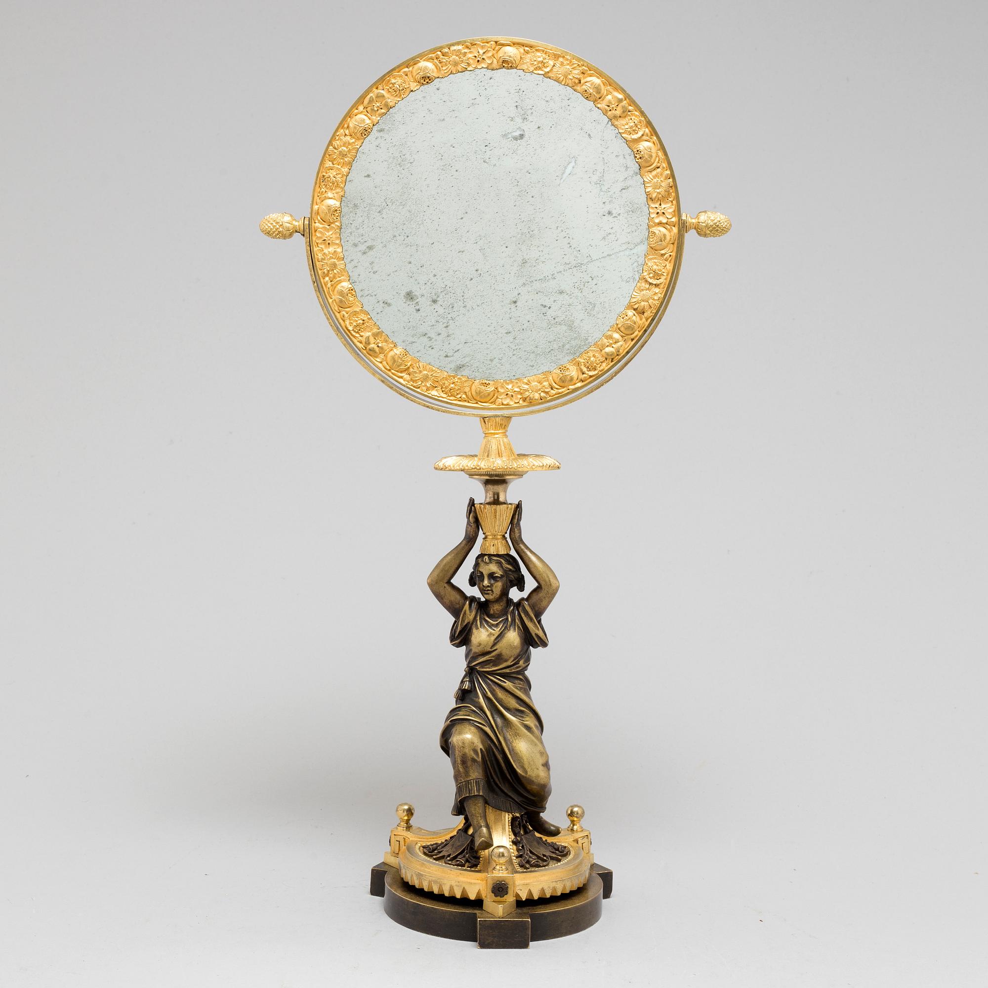 AN EMPIRE ORMOLU TABLE MIRROR, first half of the 19th century.