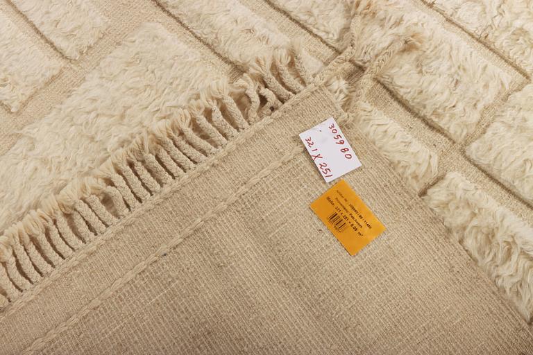 A relief-cut Moroccan carpet, c. 321 x 251 cm.