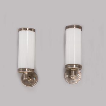 A pair of wall lights manufactured by Taito.