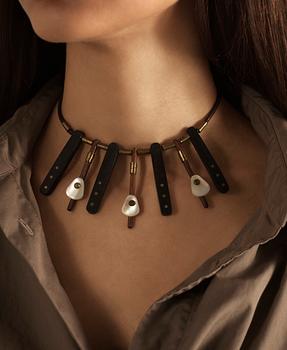 Vivianna Torun Bülow-Hübe, a necklace, wood, leather, mother-of-pearl and brass, most likely 1950's.