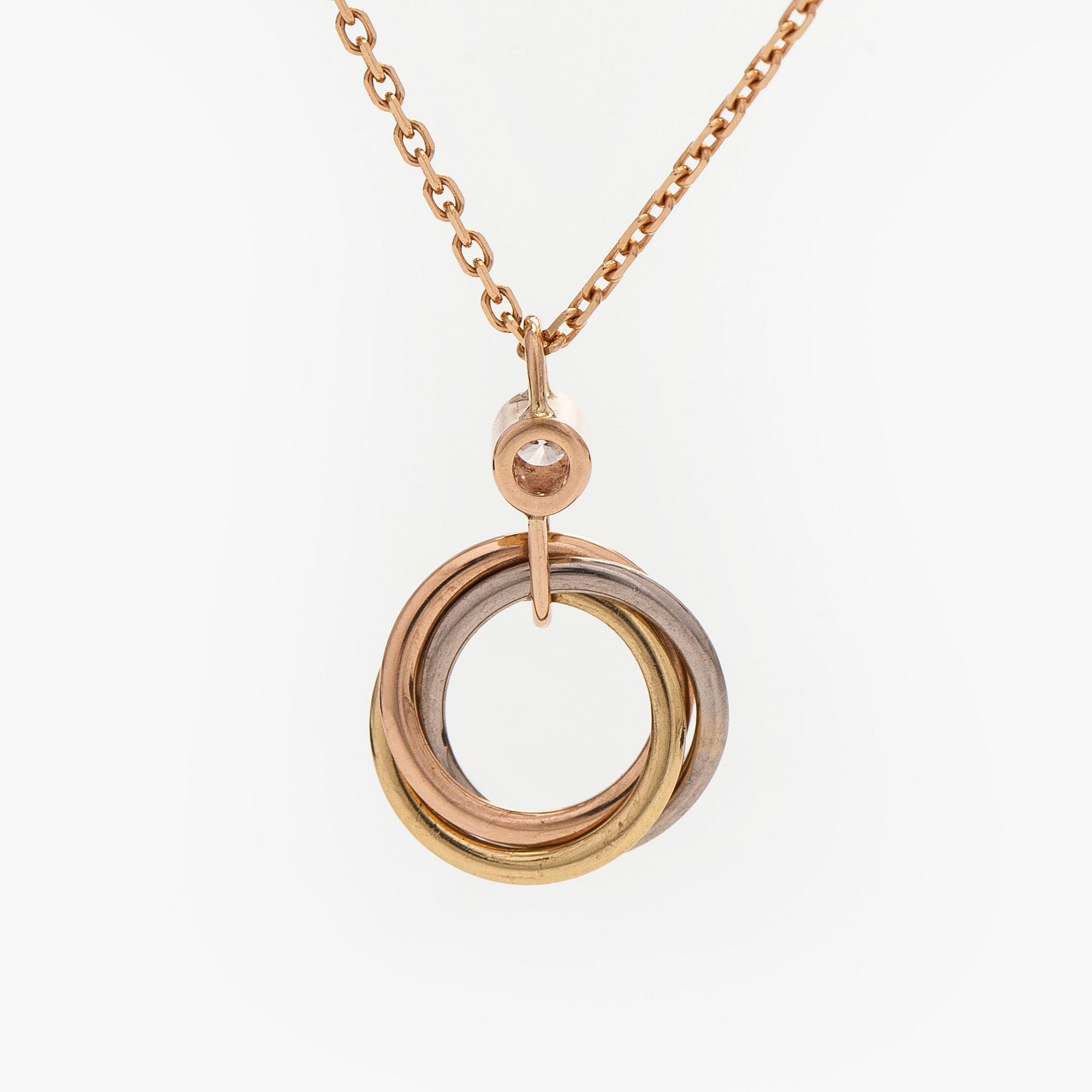 Cartier, an 18K gold 'Trinity Pendant' necklace with a brilliant-cut diamond.