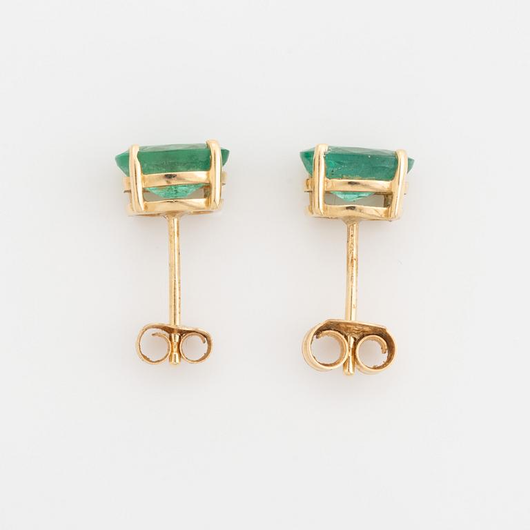 Gold and oval emerald earrings.