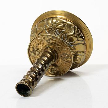 A Baroque brass candle stick, 18th century.