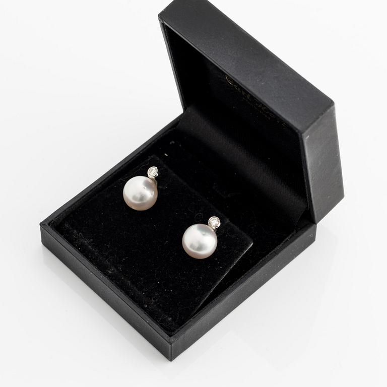 A pair of 18K gold earrings with cultured pearls and round brilliant-cut diamonds.