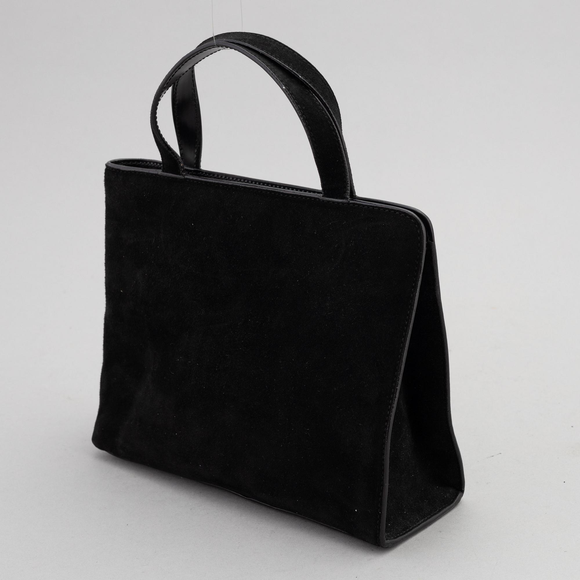 Gucci, a black suede handbag.