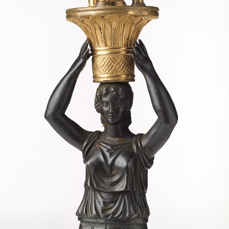 A pair of French Empire early 19th century three-light candelabra.