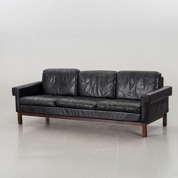 A BLACK LEATHER SOFA.