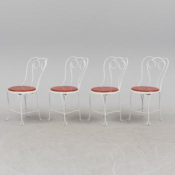 A garden table and four chairs, first half 20th century.