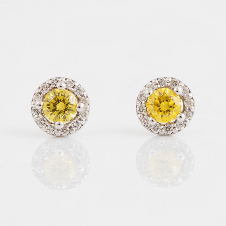 A pair of 18K gold earrings set with color treated yellow diamonds.
