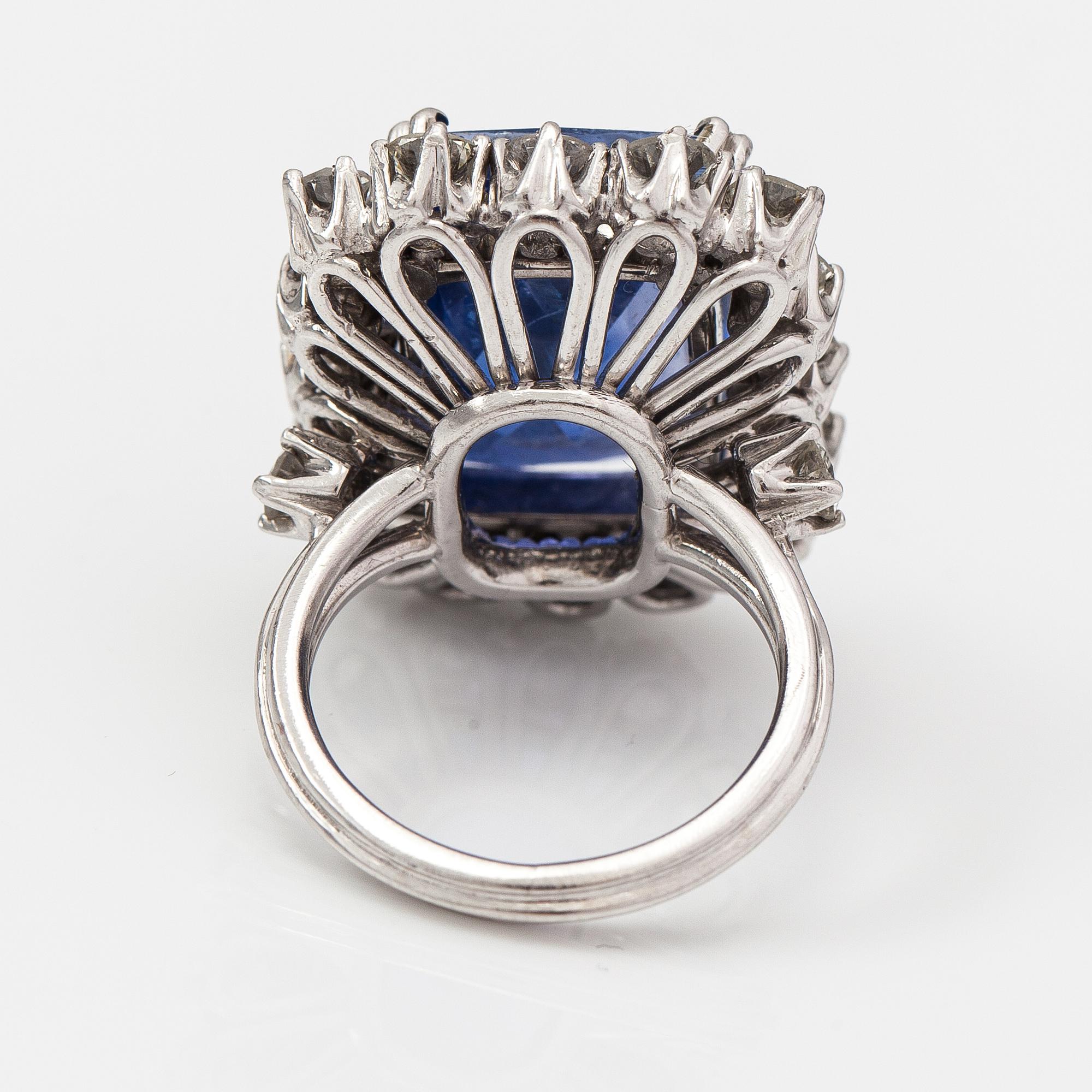 A platinum ring with a ca. 18.00 ct sapphire and ca. 3.00 cts of diamonds. With certificates.