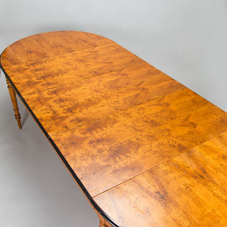 A birch veneered dining table, second half of the 19th Century.