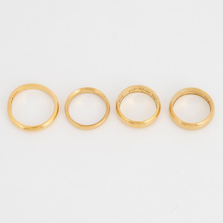 Four 23K gold rings.