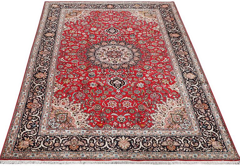 A Tabriz, 50RAJ, part silk carpet, c. 325 x 208 cm.