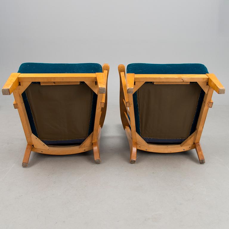 A pair of mid 20th century '2402 Armi' armchairs by Ilmari Lappalainen/Olavi Lieto, Asko, Finland.