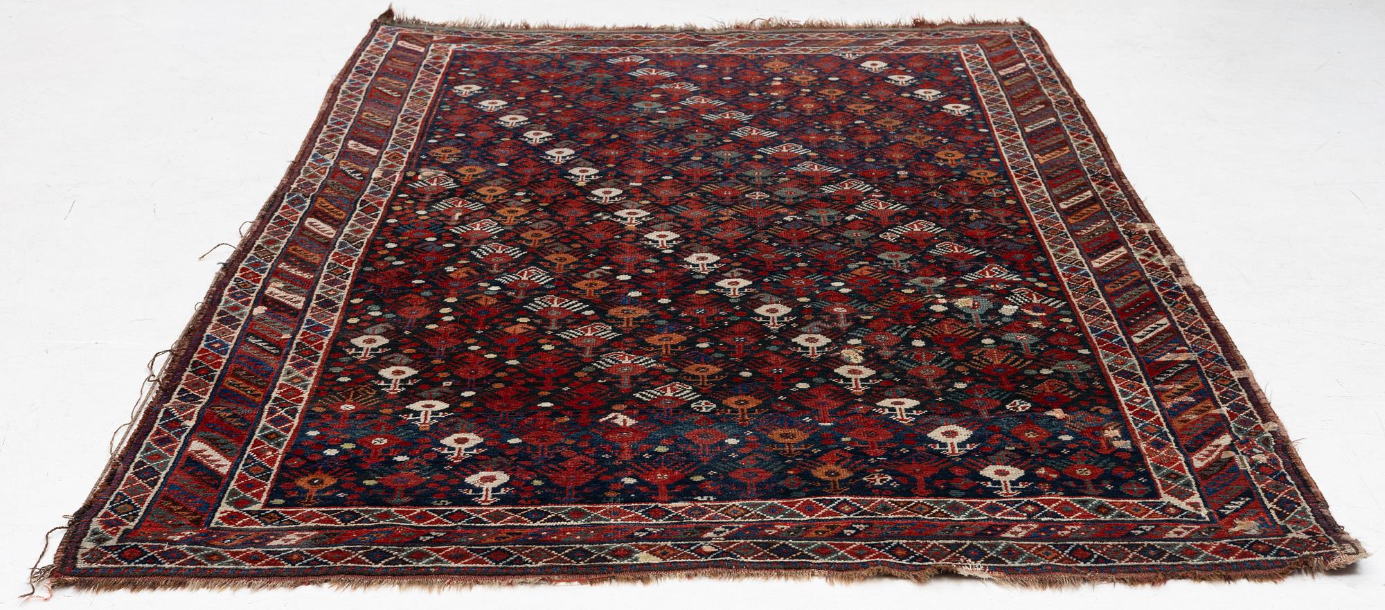 An antique Qashgai rug, 230 x 135 cm.