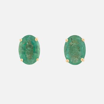 Gold and oval emerald earrings.