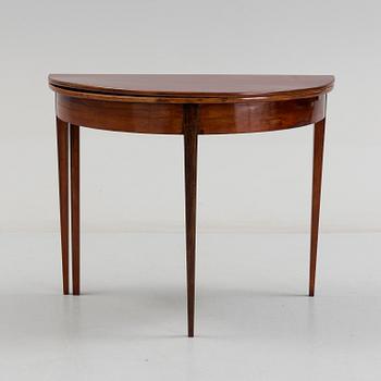 A first half od the 19th century game table veneered with mahogny.