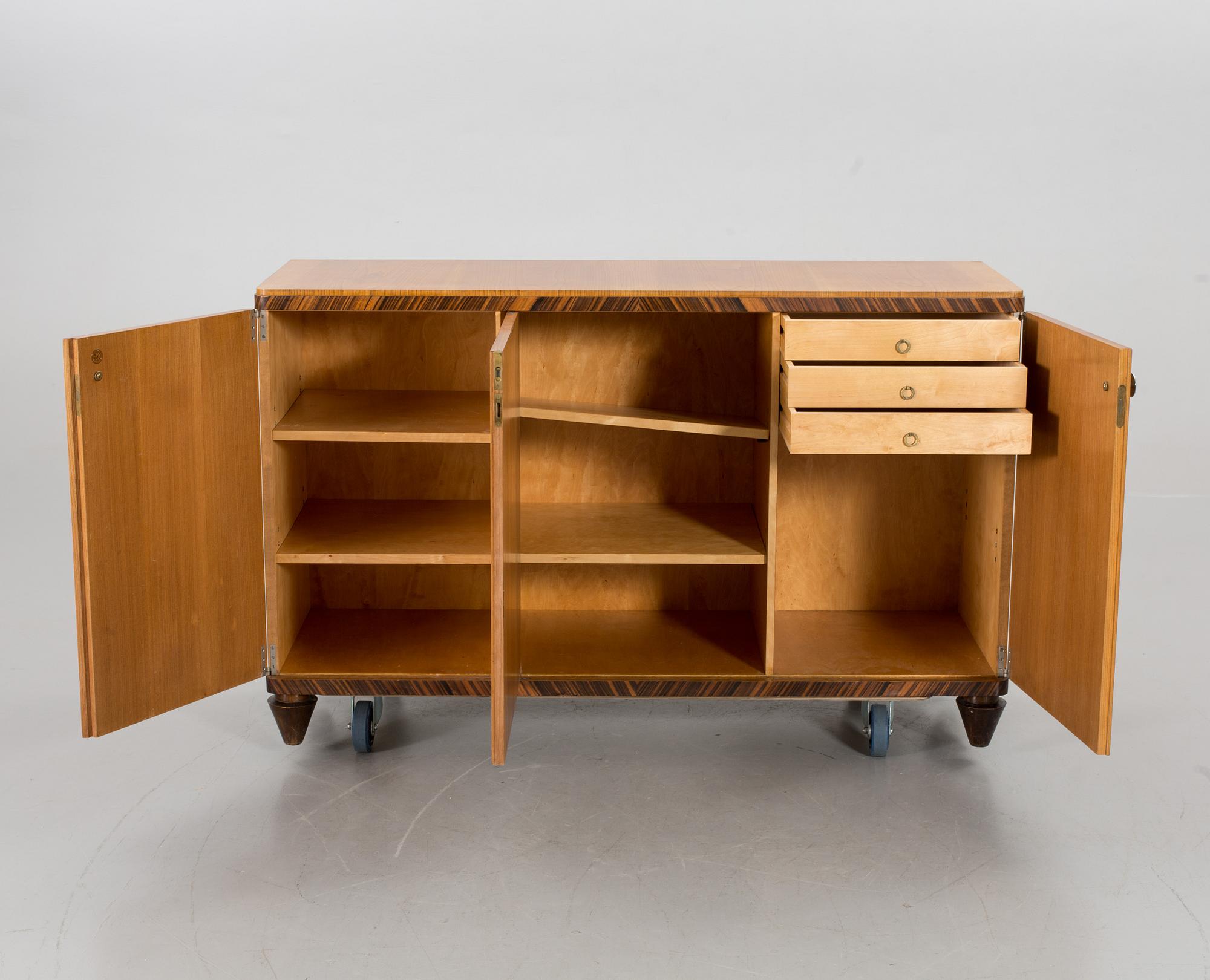 A "MODEL OK" SIDEBOARD DESIGNED BY AXEL EINAR HJORTH FOR NORDISKA KOMPANIET.