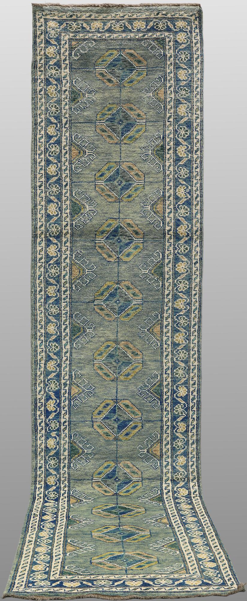 An Oriental runner, c. 393 x 79 cm.