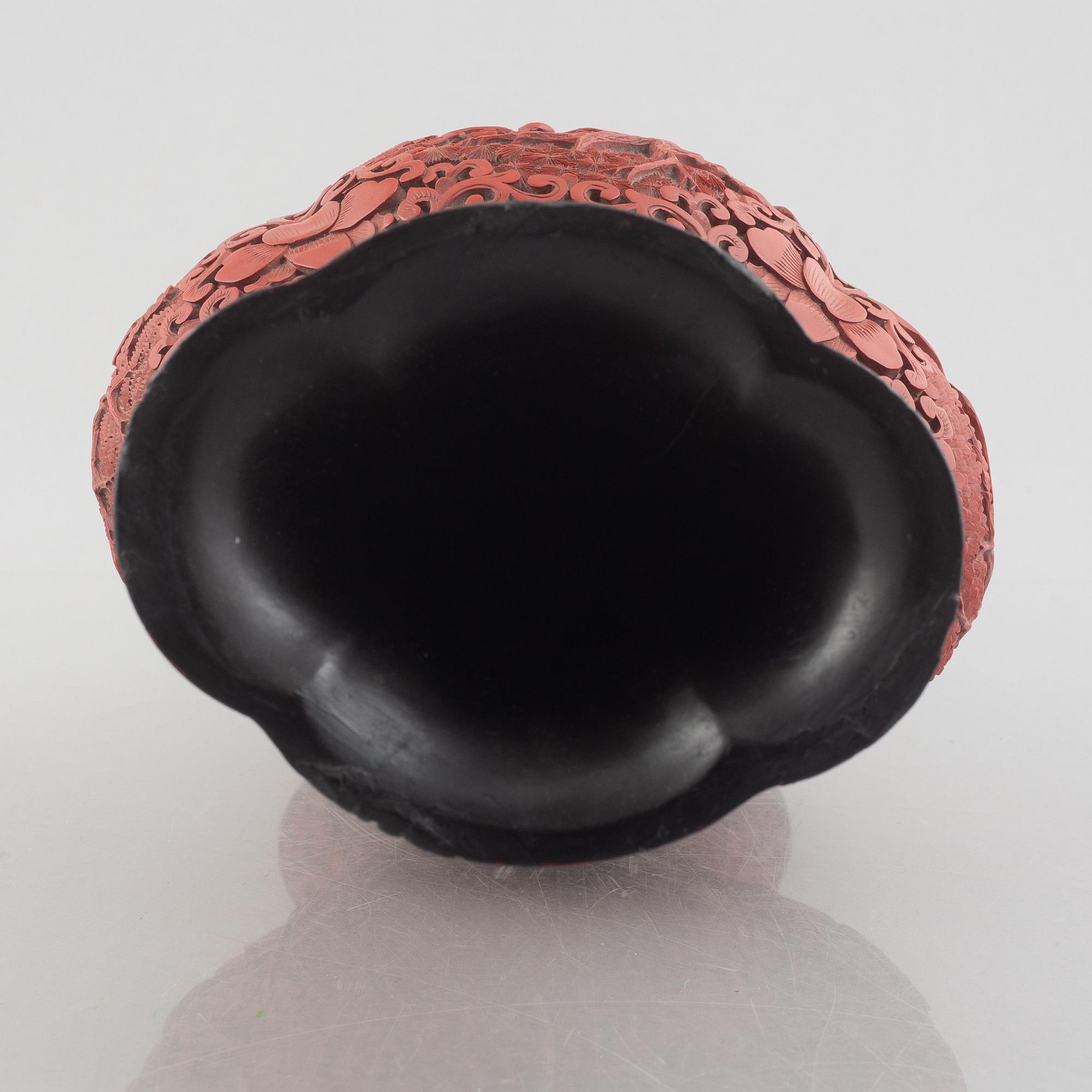 A red laquer vase, early 20th century.
