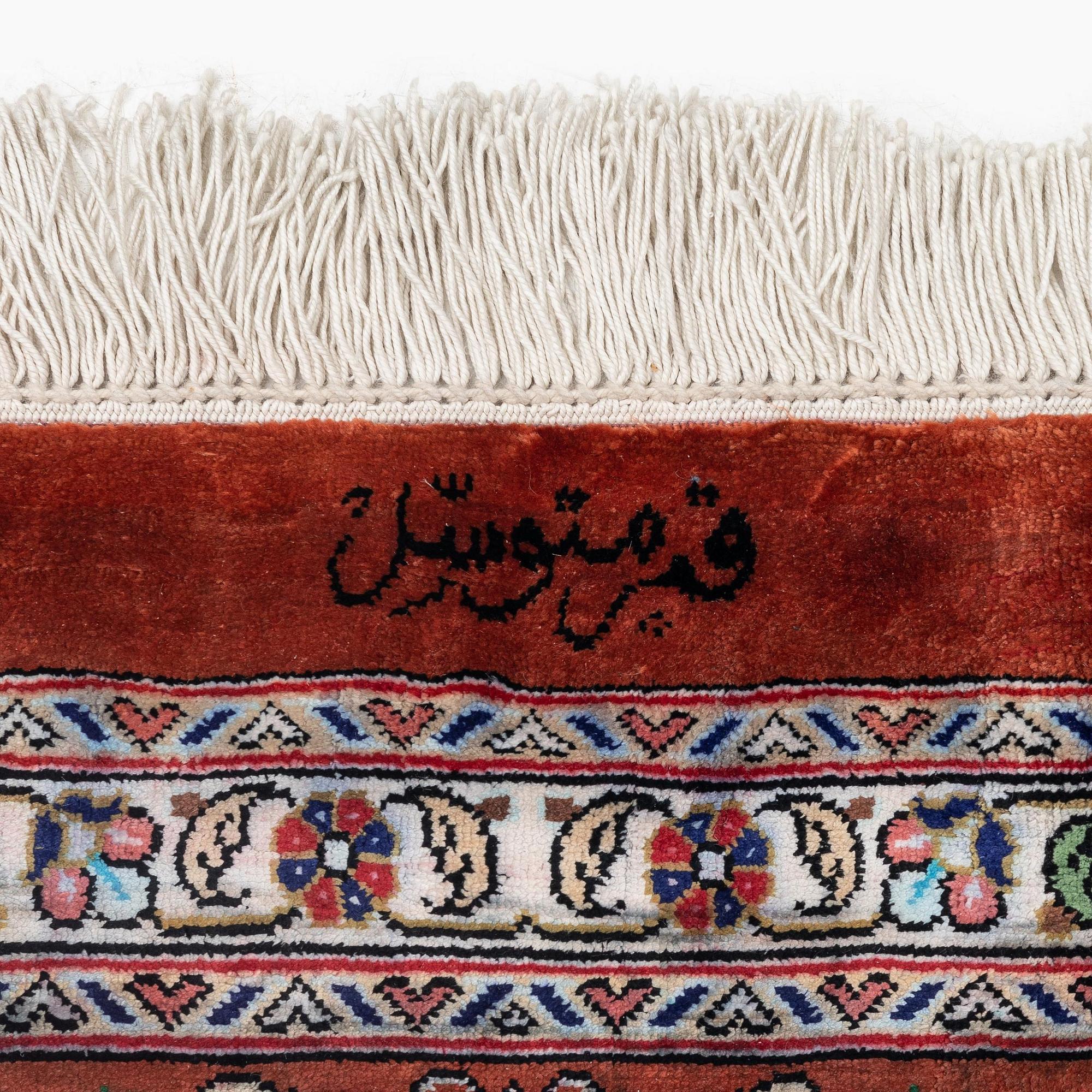 A signed pictoral silk Qum rug, c. 203 x 127 cm.