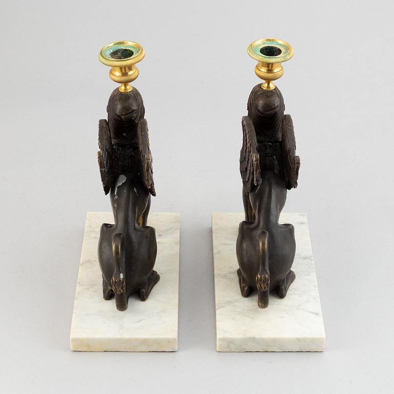 A pair of bronze and marble Empire style candlesticks, first part of the 20th Century.