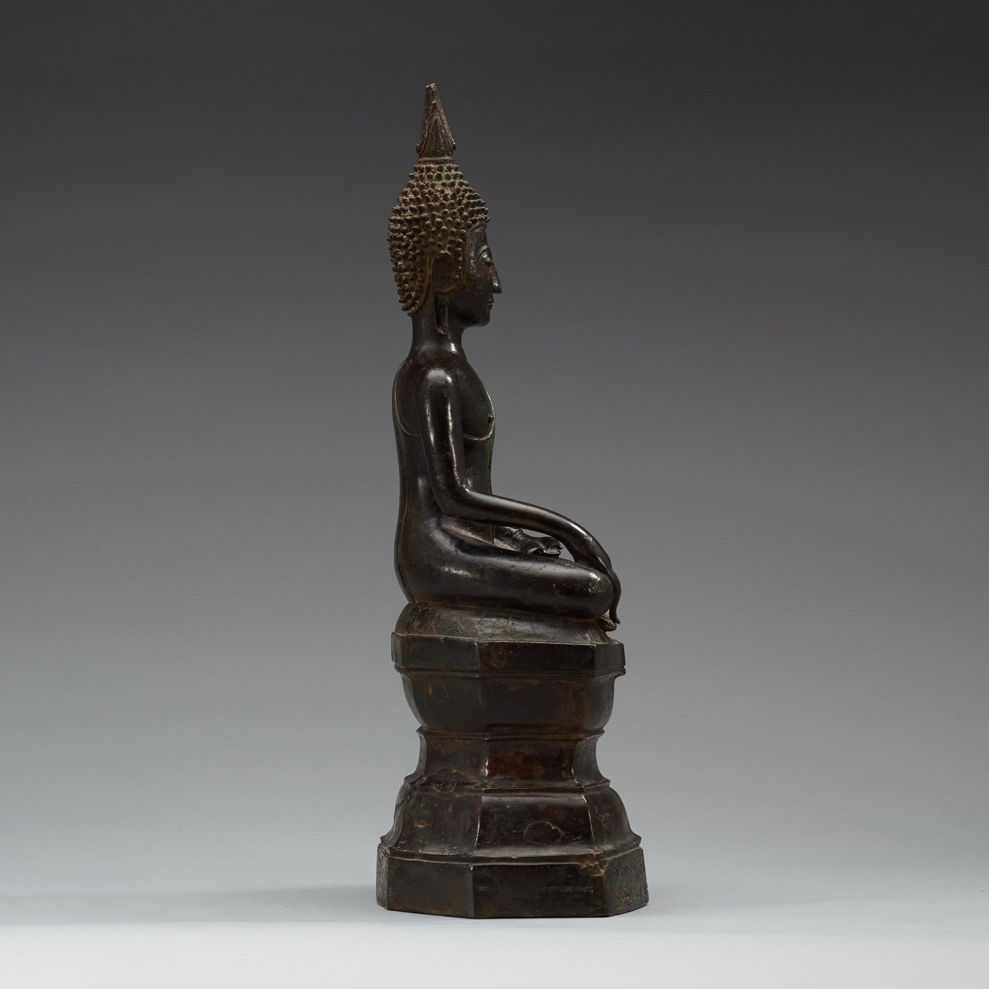 A large seated bronze figure of buddha, Thailand, 19th Century or older. With inscription to base.