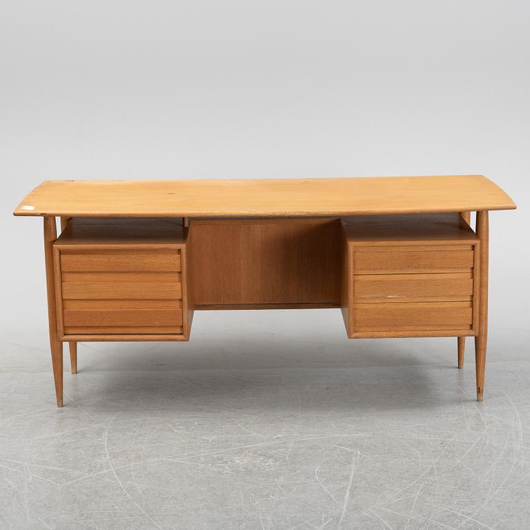 A teak veneered writing desk, 1950's/60's.