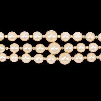 A necklace by Christian Dior with three strand decorative pearls.