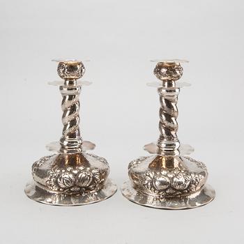 A pair of silver baroquestyle candlesticks. W.H.H, Stockholm. 1935. Filled foot.