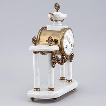 A French mantlepiece clock and a pair of candelabras, first half of the 20th century.