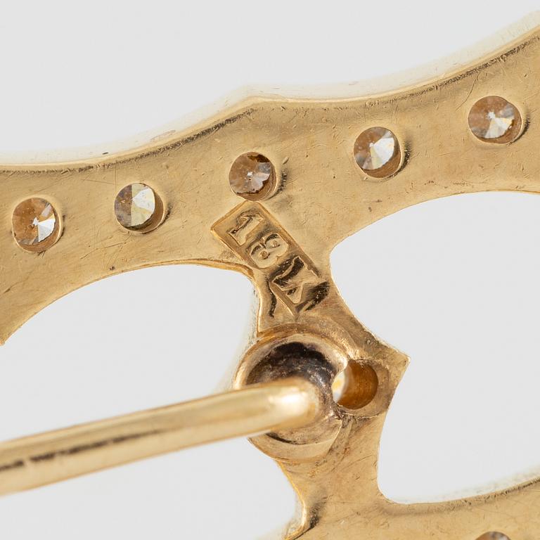 Kravattnål, i form av "H", 18K guld med briljantslipade diamanter.