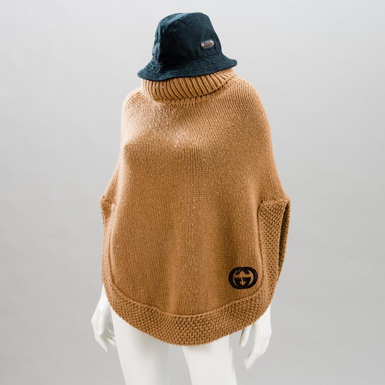 GUCCI, CAMEL HAIR PONCHO AND A HAT.