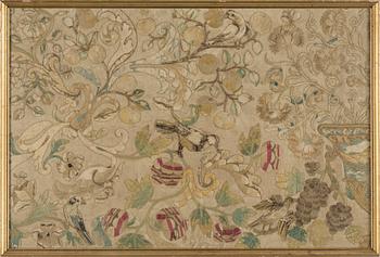 AN EMBROIDERED TEXTILE FRAGMENT, Europe 18th century, ca 55,5 x 83,5 cm (with the frame 60,5 x 87 cm).
