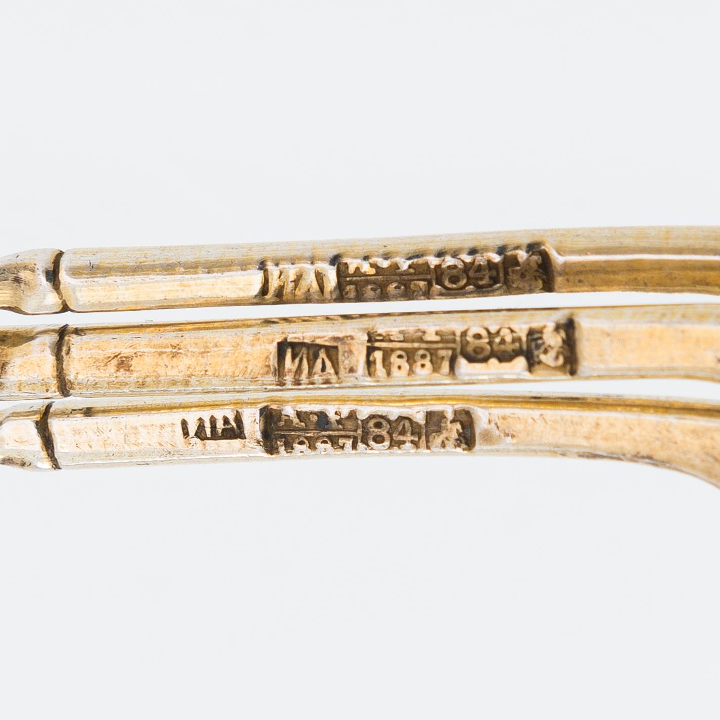 Twelve parcel-gilt teaspoons and a jam spoon, Russia 1887-1926.